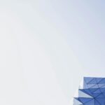 Abstract geometric architecture with clear sky and copy space, perfect for modern design backgrounds.